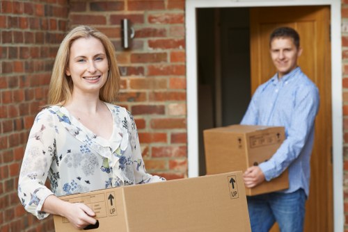 Local moving team handling furniture in a Fulham street