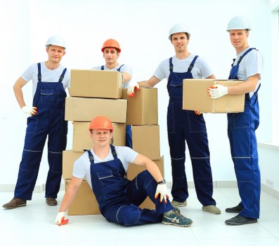 Professional movers carrying furniture in a Fulham home