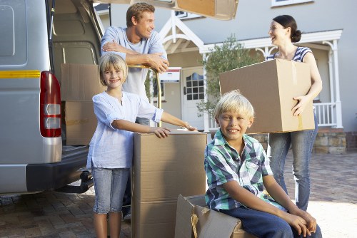 Professional movers unloading boxes at a Fulham flat